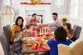 Family With Grandparents Enjoying Thanksgiving Meal At Table Royalty Free Stock Photo