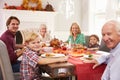 Family With Grandparents Enjoying Thanksgiving Meal At Table Royalty Free Stock Photo