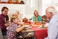 Family With Grandparents Enjoying Thanksgiving Meal At Table Royalty Free Stock Photo