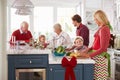 Family With Grandparents Preparing Christmas Meal In Kitchen Royalty Free Stock Photo