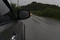 Beside of family gray car stop on asphalt road with rain. Royalty Free Stock Photo