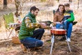 Family grilling meat on barbecue Royalty Free Stock Photo