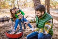 Family grilling meat on barbecue Royalty Free Stock Photo