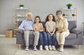 Portrait of happy grandparents and little grandchildren sitting on the sofa at home Royalty Free Stock Photo