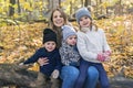 Family Group Relaxing Outdoors In Autumn Landscape sit on log Royalty Free Stock Photo