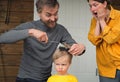 Family haircut at home during quarantine when closed all hairdressers. Father cut hair for son and mother is shocked by it. Beauty