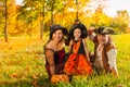 Family in Halloween costumes sitting on the grass Royalty Free Stock Photo