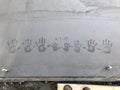 Family handprints in fresh concrete