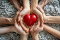 Family hands holding red heart top view Royalty Free Stock Photo