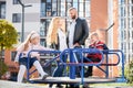 Family hanging out at playground in warm sunny day. Royalty Free Stock Photo