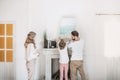 Family hanging picture of sea over the fireplace at home Royalty Free Stock Photo