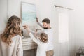 Family hanging picture of sea over the fireplace at home Royalty Free Stock Photo