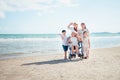 Family happily chatted with Grandma on the beach wheelchair Royalty Free Stock Photo