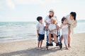 Family happily chatted with Grandma on the beach wheelchair Royalty Free Stock Photo