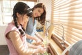 Family Happy Asian mother and daughter washing vegetables meal preparation together at kitchen