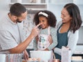 Family, happy and cooking flour face fun with caring dad, mother and cute daughter in home kitchen. Wellness, baking and