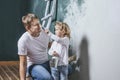 Family, happy daughter with dad doing home repair, paint walls, Royalty Free Stock Photo