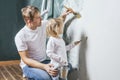 Family, happy daughter with dad doing home repair, paint walls, Royalty Free Stock Photo