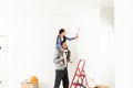 Family, happy daughter with dad doing home repair, paint walls, together with love Royalty Free Stock Photo