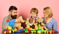 Family with happy faces hold teddy bears and construction blocks Royalty Free Stock Photo