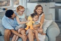 Family, happy and parents with children, love and spending quality time together on sofa in family home. Mother, father Royalty Free Stock Photo