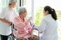 Family happy senior asian woman and doctor or nurse talking,enjoying together,female caregiver or friendship supporting smiling Royalty Free Stock Photo