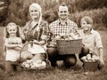 Family harvesting apples in garden