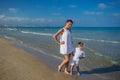 Family has fun at the seashore in summertime Royalty Free Stock Photo