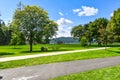 A family has a picnic in the shade of a tree with the Lake and marina in the distance at McEuen Park in Coeur d`Alene Idaho Royalty Free Stock Photo