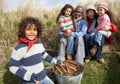 Family Having Barbeque On Winter Beach