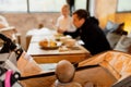 Family having breakfast in cafeteria at morning. Whole wheat waffles, ice cream, kiwi and coffee on brown wooden rustic Royalty Free Stock Photo