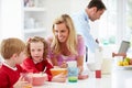 Family Having Breakfast In Kitchen Before School And Work Royalty Free Stock Photo