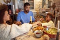 Family having Christmas prayer for dinner at home