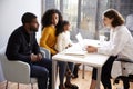 Family Having Consultation With Female Pediatrician In Hospital Office Royalty Free Stock Photo