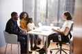 Family Having Consultation With Female Pediatrician In Hospital Office Royalty Free Stock Photo