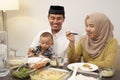 Family having early breakfast before dawn