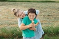 Family is having fun on the background of green grass, eating ice cream and laughing. Parent-teen relationship concept