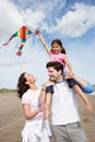 Family Having Fun Flying Kite On Beach Holiday Royalty Free Stock Photo