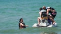 Family having fun on jet ski at beach island Royalty Free Stock Photo