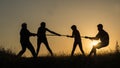 Family having fun in nature - playing tug of war