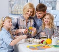 Family having fun painting and decorating easter eggs. Royalty Free Stock Photo