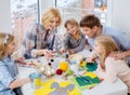 Family having fun painting and decorating easter eggs.