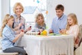 Family having fun painting and decorating easter eggs. Royalty Free Stock Photo