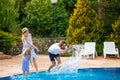 Family having fun their pool. family splashing water with legs or hands in swimming pool Royalty Free Stock Photo