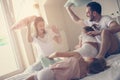 Family having funny pillow fight on bed. Royalty Free Stock Photo