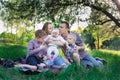 Family having a great time outdoors. Mom, dad and three children. Father kissing daughter