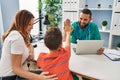 Family having medical consultation high five with hands raised up at clinic Royalty Free Stock Photo