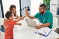Family having medical consultation high five with hands raised up at clinic Royalty Free Stock Photo