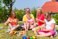 Family having picnic in garden front of their home