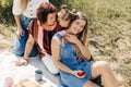 The family is having a picnic on the lawn. Three generations of women of the same family rest together Royalty Free Stock Photo